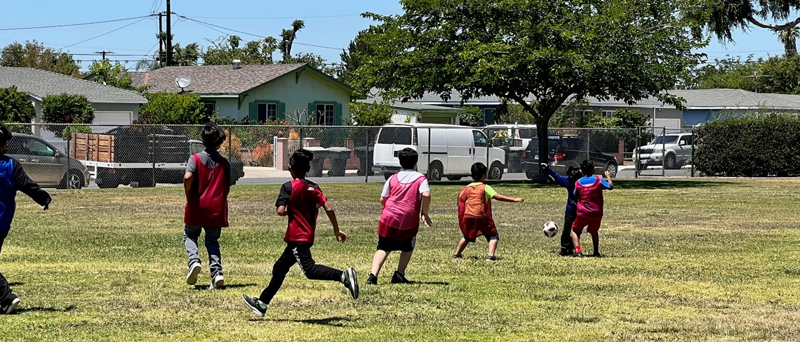 Students play soccer during lunch.