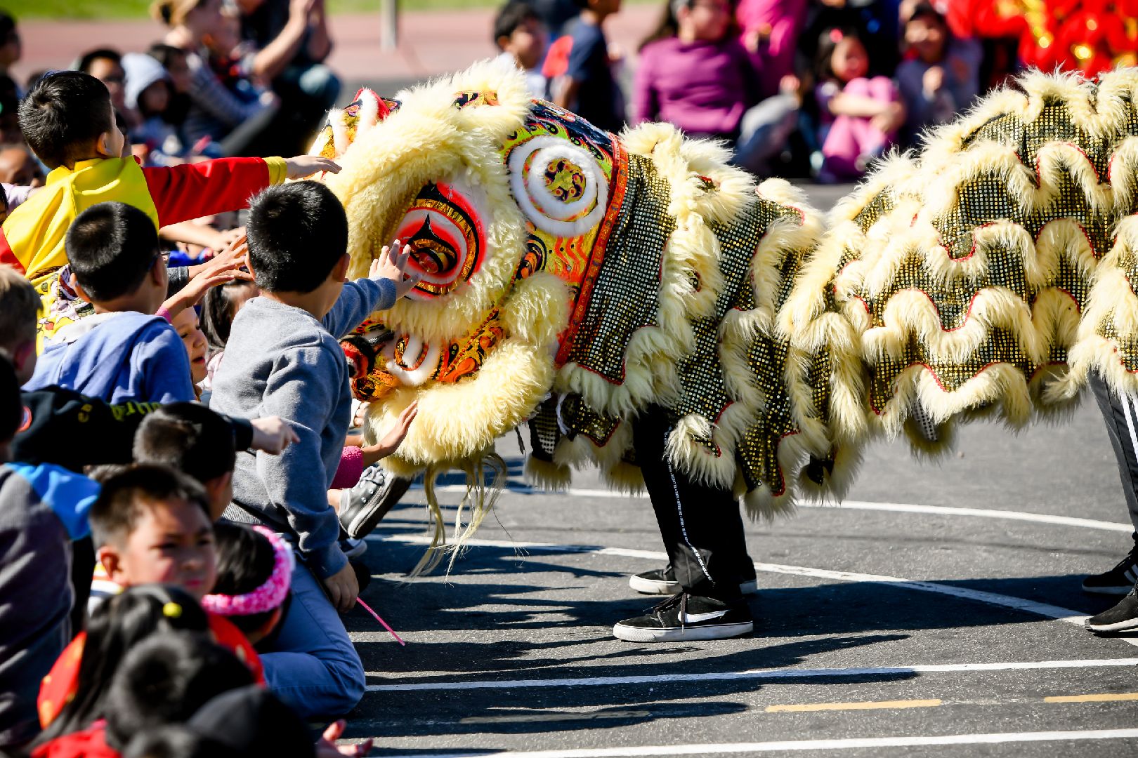 Lion Dancer greeting students.