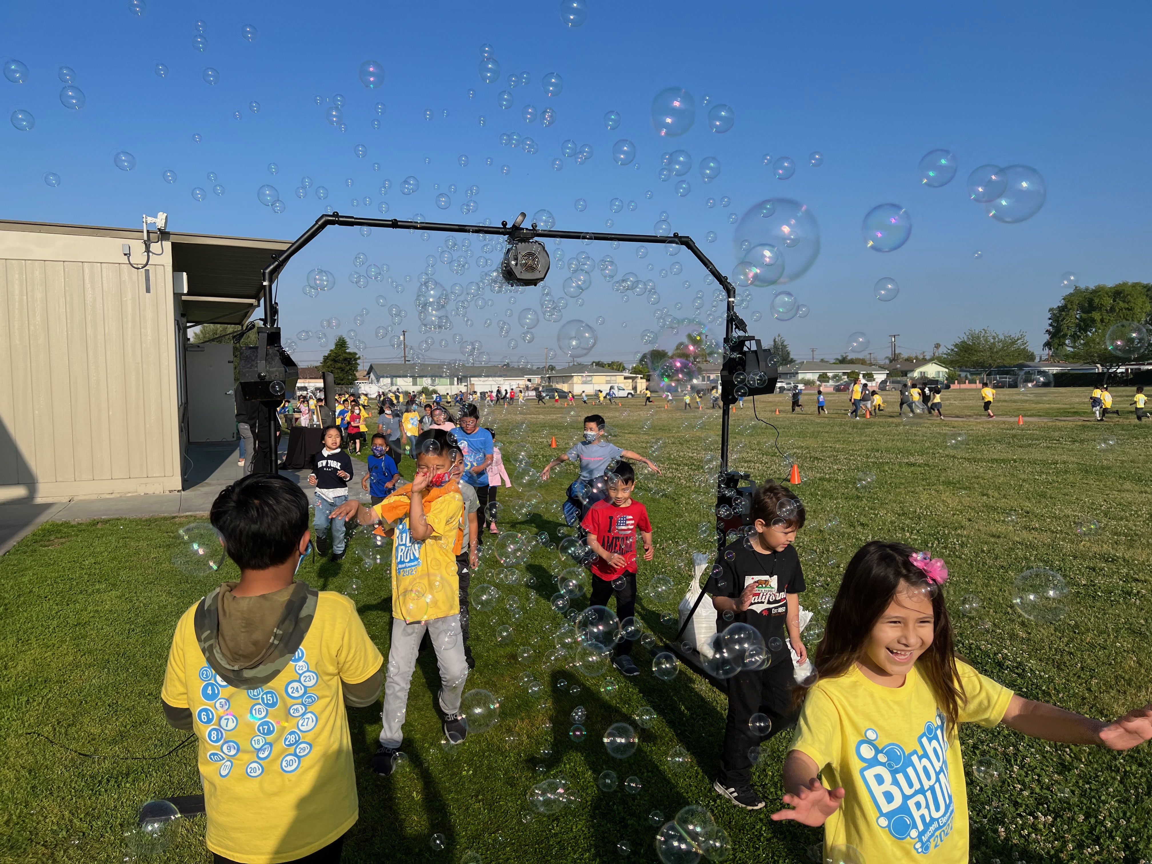 Students run through bubbles at the Bubble Run.