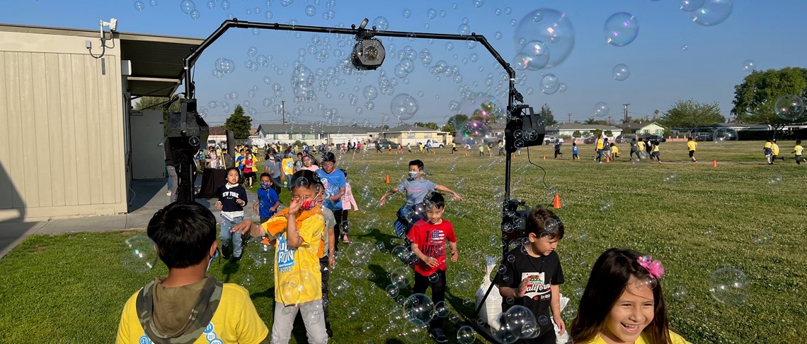 Students run through bubbles at the Bubble Run.